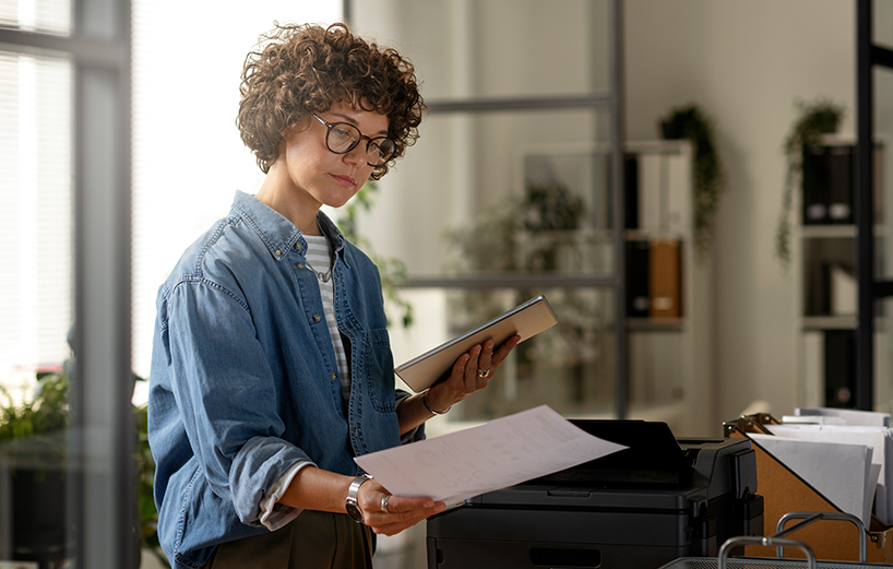 Person analyzing financial data on multiple monitors, representing banking operations